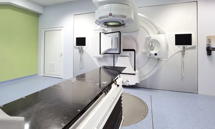 Patient positioned on the treatment table with alignment lasers before breast radiation